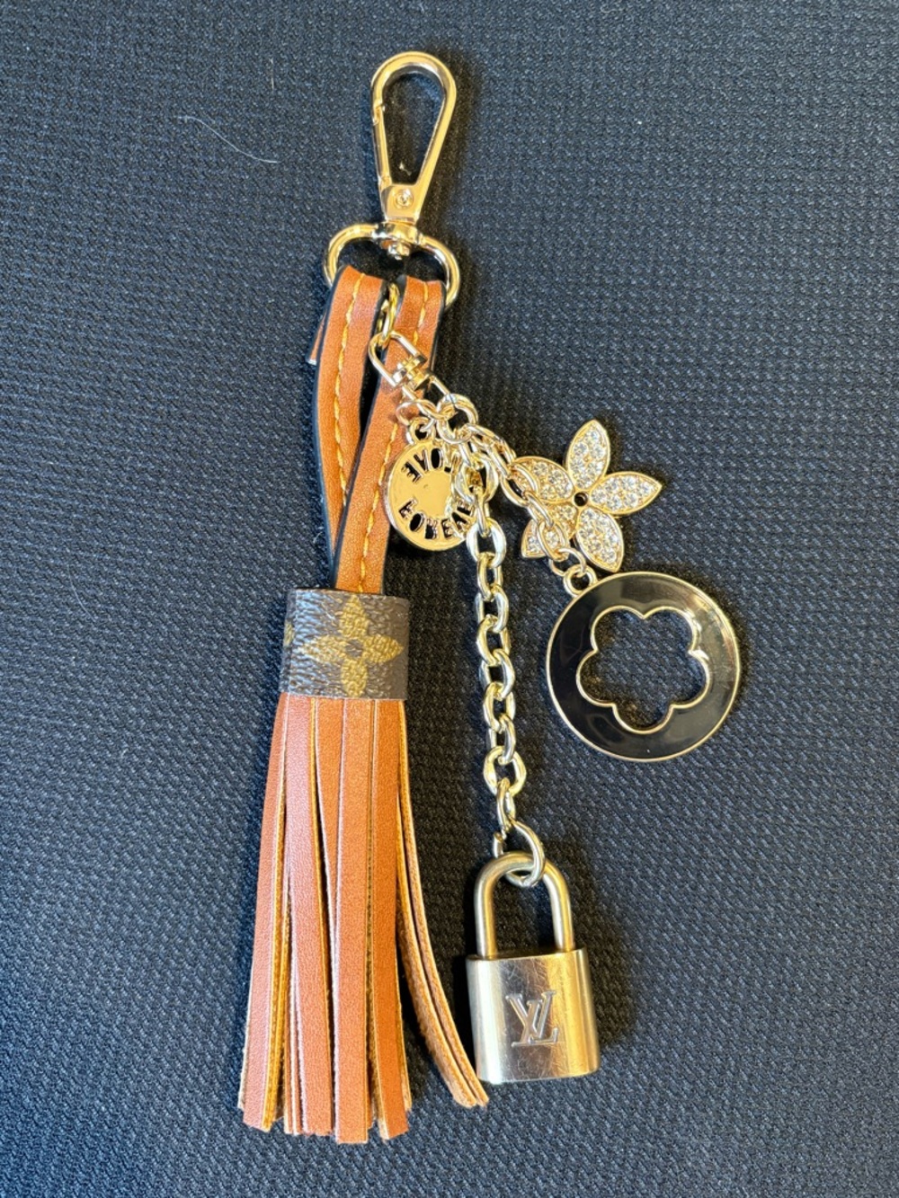 Authentic Louis Vuitton lock on leather tassel with unbranded charms (No Key)